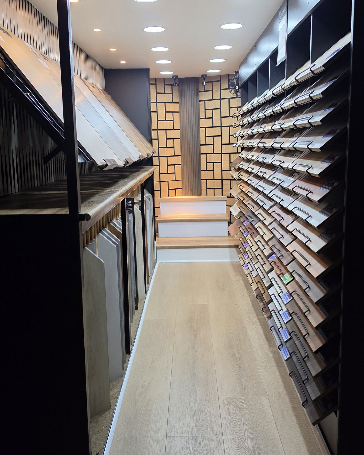 Inside the iProStep mobile showroom trailer, with flooring samples and a display stair